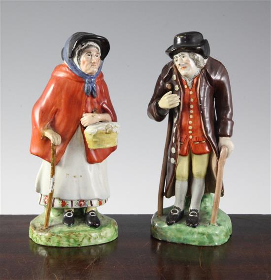 A pair of Staffordshire pearlware figures of an elderly lady and gentleman, c.1830, height 18cm (7.1in.), restorations